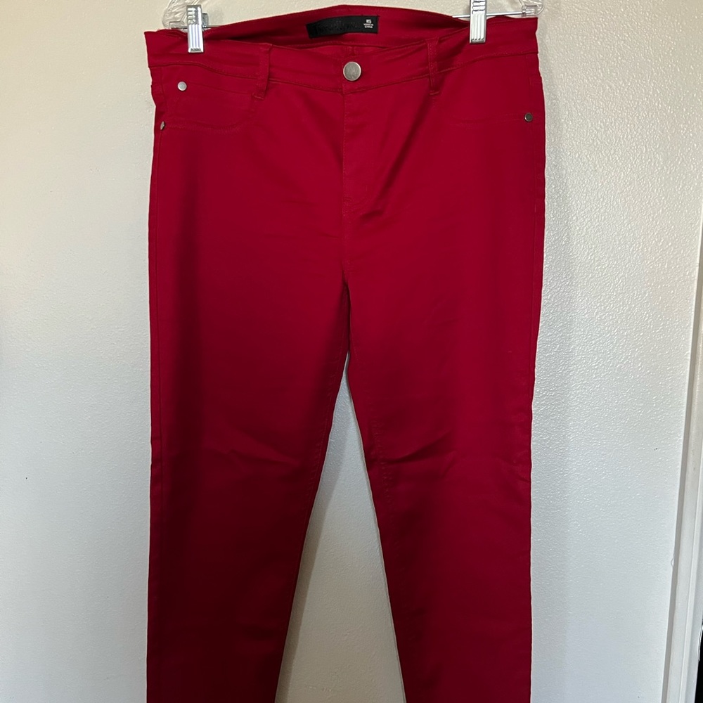 Red stretchy pants, skinny, regular length.